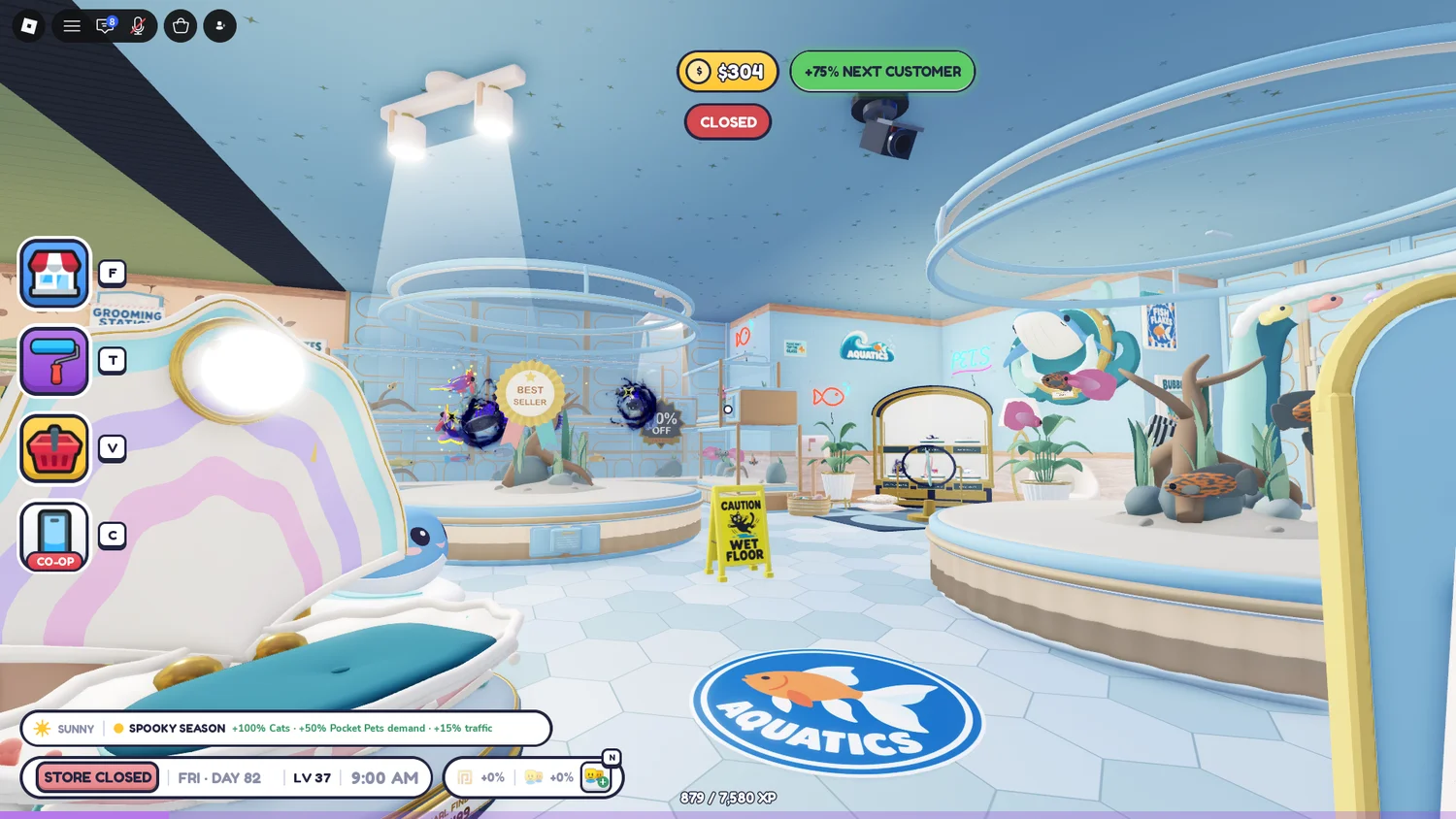 A pale blue aquatics section with round fish tanks, white flooring and an Aquatics floor sign.