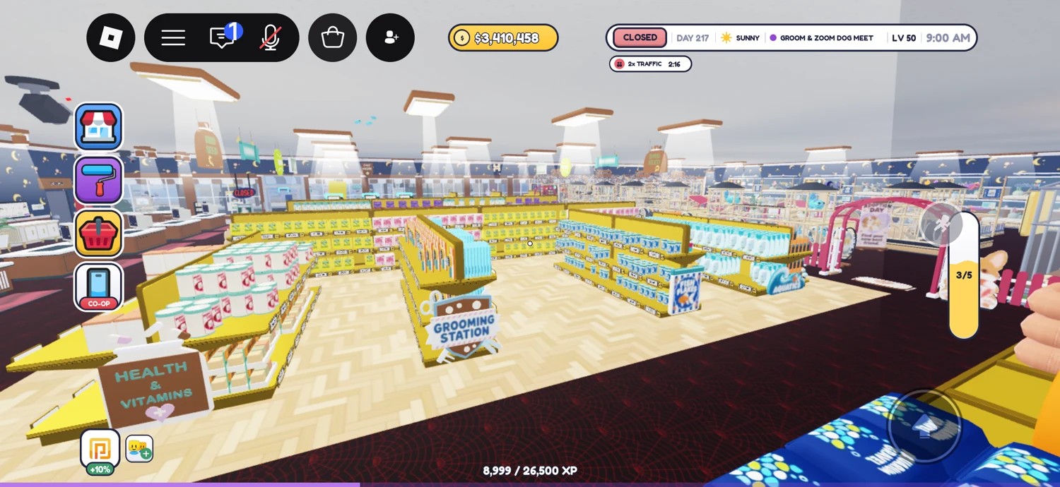 Wide view across the sales floor, showing parallel stocked shelves and signs on pale wood.