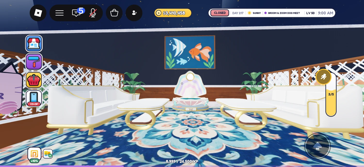 Aquarium seating corner with white-and-gold sofas, a fountain, fish artwork and a floral rug.