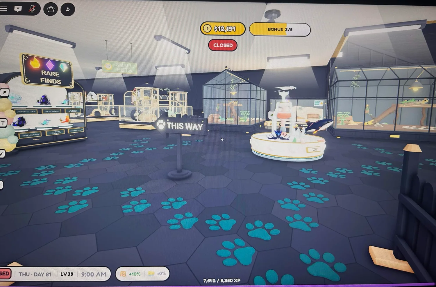 Teal paw-print paths branching around a fountain toward tall animal enclosures and a direction sign.
