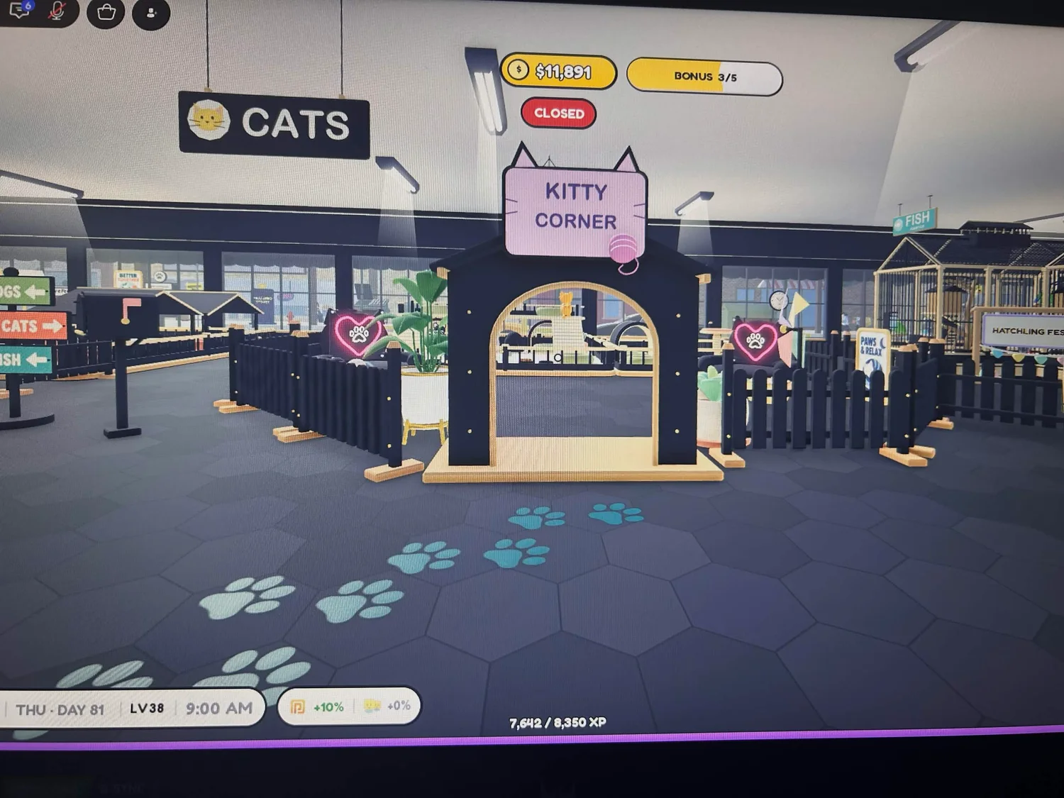 A Kitty Corner entrance with gold trim, heart decorations and teal and white paw prints.