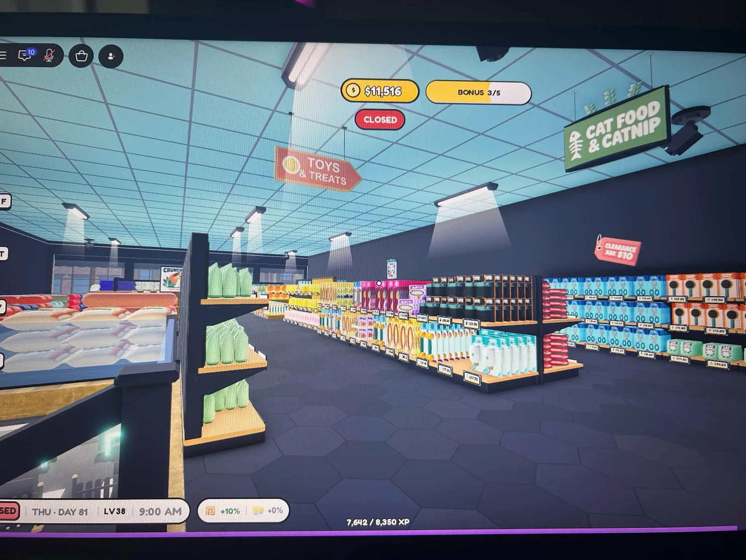 Stocked merchandise rows beneath Toys and Treats and Cat Food and Catnip signs.