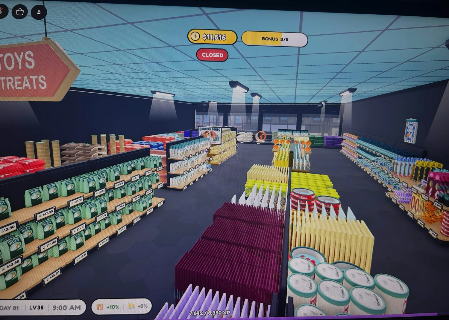 A view down the merchandise aisles, with colourful stock on dark shelves beneath a blue ceiling.